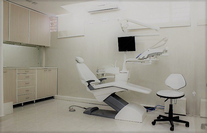 Dental World founders standing beside a dental chair in the treatment room